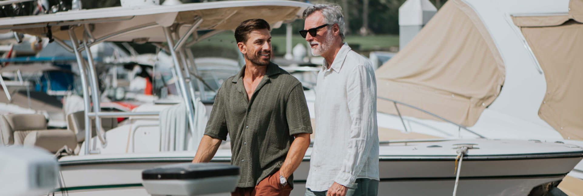 A young man and an older gentleman walking through the Marina at JA Lake View Hotel